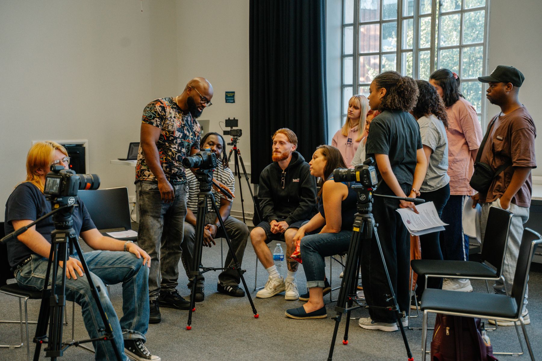 People gathered around cameras in a room